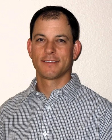 headshot of a man with short dark hair