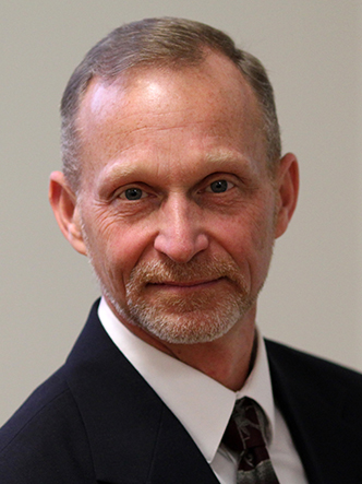 man with short gray hair in suit and tie