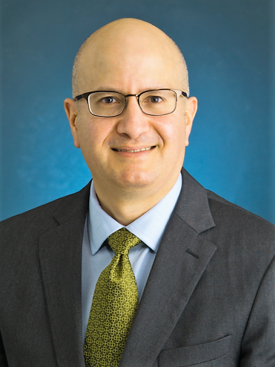 man with glasses wearing suit and tie