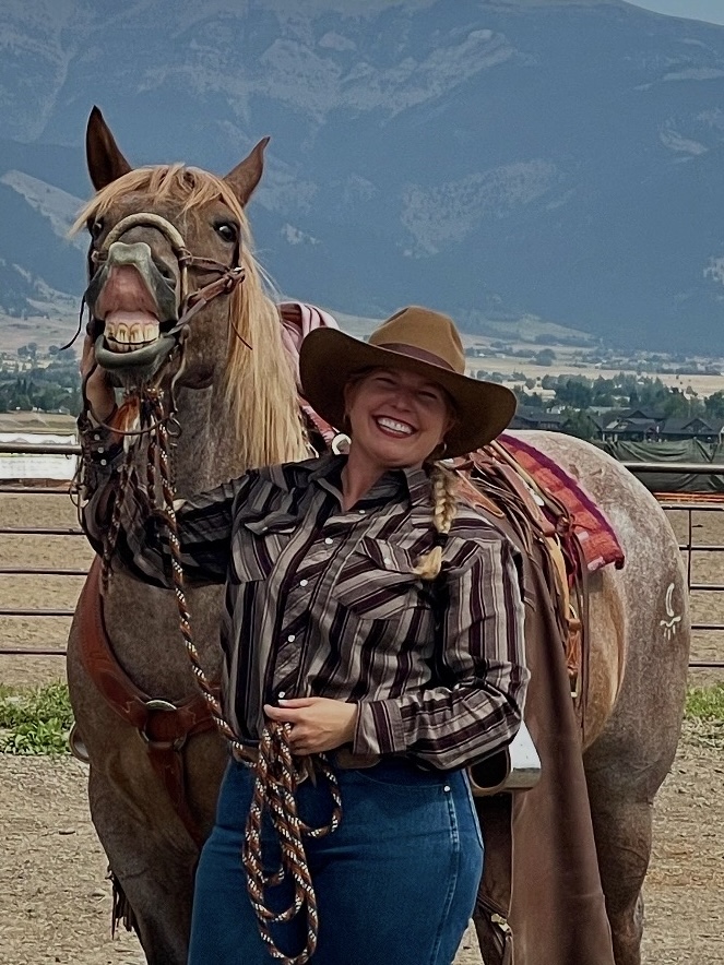 A woman in cowgirl hat with a smiling horse