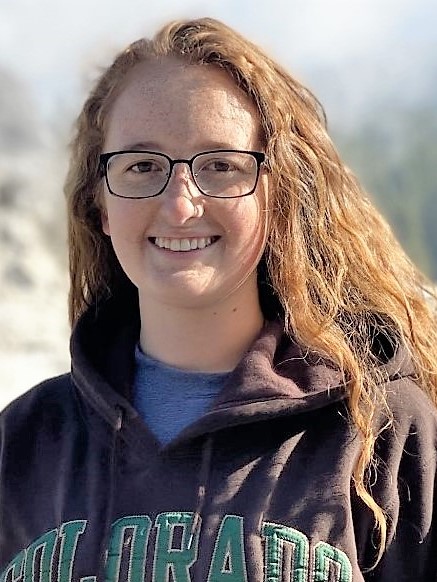 Smiling woman with long, curly red hair