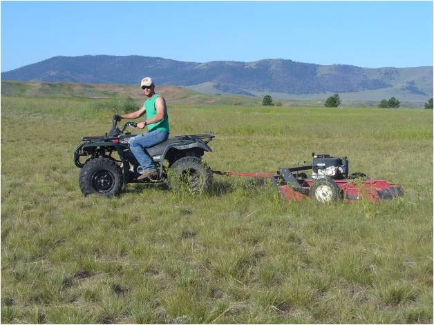 Student on ATV with attachment