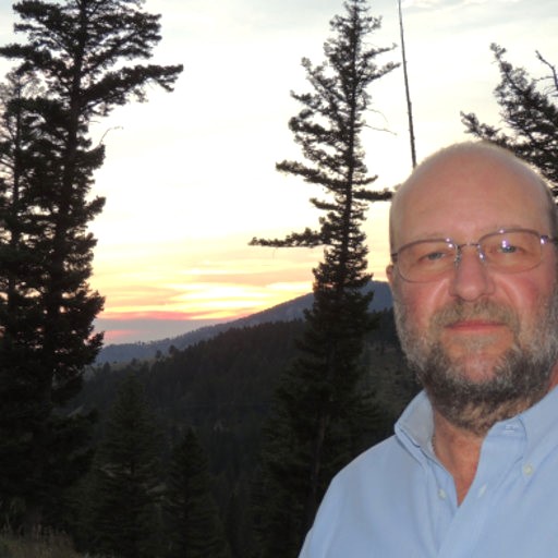 A man in glasses in the outdoors