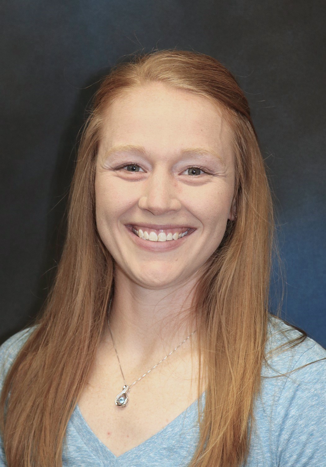 A woman with long strawberry blonde hair