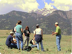 Dr. Wambolt (right) discussing range ecology with students during a Yellowstone Range Ecology class. Photo of Carl Wambolt