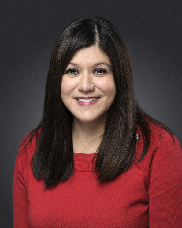 Portrait of woman with long dark hair and a red sweater